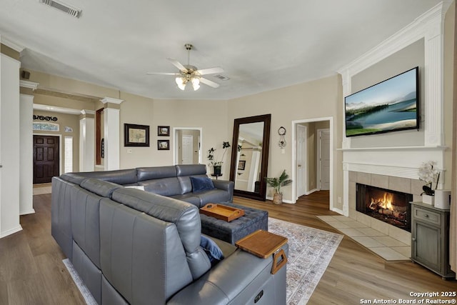 2363 Oak Pebble, New Braunfels, TX 78132 - living area featuring ceiling fan, a tile fireplace, wood finished floors, and decorative columns