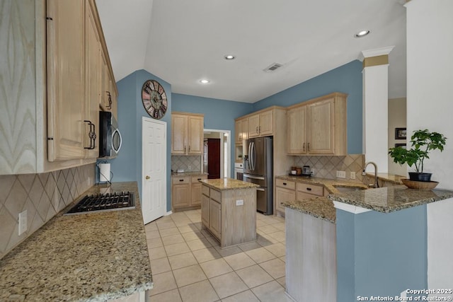 2363 Oak Pebble, New Braunfels, TX 78132 - kitchen with appliances with stainless steel finishes, light brown cabinets, decorative backsplash, a peninsula, and light stone counters