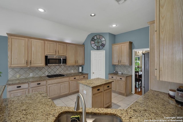 2363 Oak Pebble, New Braunfels, TX 78132 - kitchen with appliances with stainless steel finishes, light brown cabinetry, tasteful backsplash, light tile patterned floors, and light stone counters