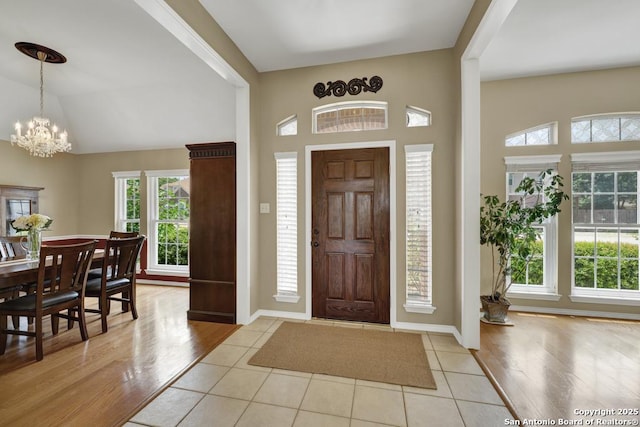 2363 Oak Pebble, New Braunfels, TX 78132 - entrance foyer featuring healthy amount of natural light, a chandelier, vaulted ceiling, and light wood-style floors