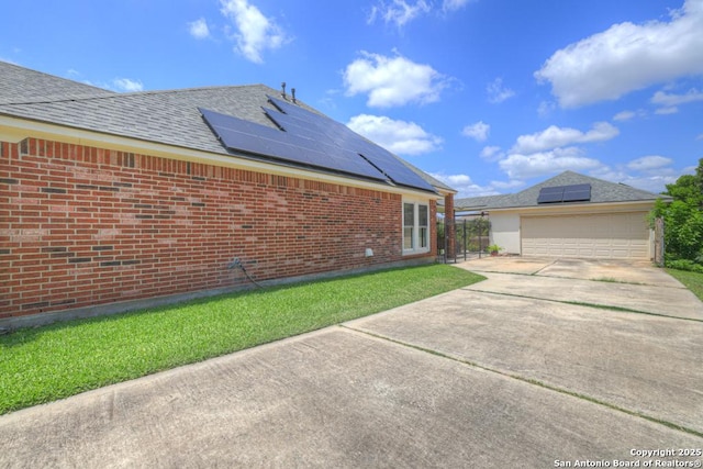 2363 Oak Pebble, New Braunfels, TX 78132 - view of property exterior featuring solar panels, a garage, concrete driveway, and brick siding