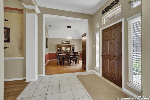 2363 Oak Pebble, New Braunfels, TX 78132 - foyer entrance featuring light tile patterned floors, a chandelier, ornate columns, and vaulted ceiling