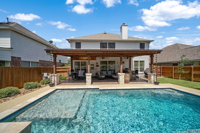 20926 Encino Dawn, San Antonio, TX 78259 - back of property with ceiling fan, a fenced backyard, an outdoor living space, a chimney, and a patio area