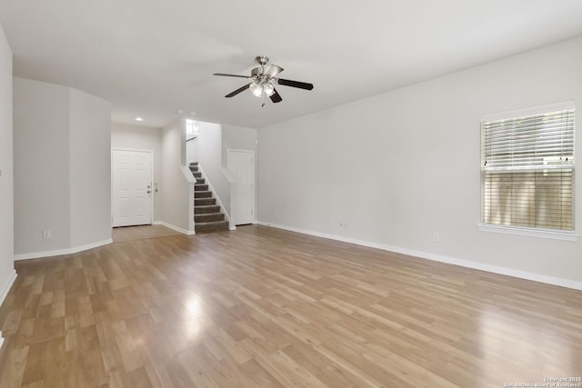 10107 Roseangel, Helotes, TX 78023 - unfurnished living room with stairway, a ceiling fan, light wood-style flooring, and recessed lighting