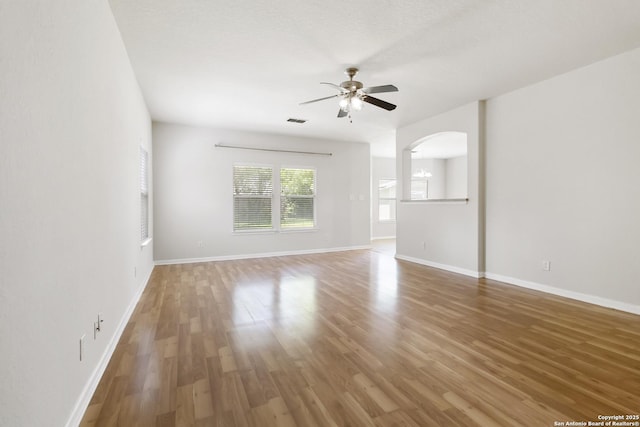 10107 Roseangel, Helotes, TX 78023 - spare room with a ceiling fan, wood finished floors, and arched walkways