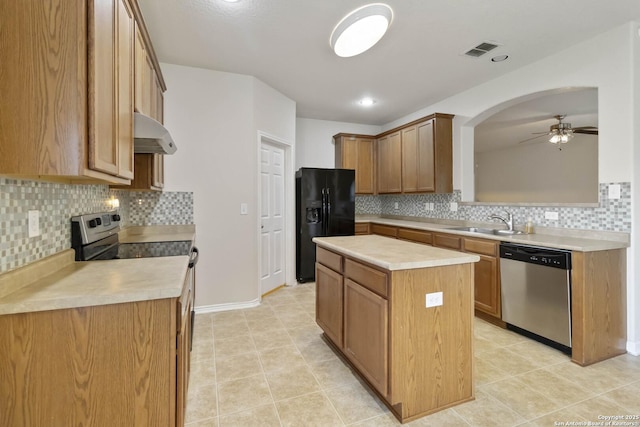10107 Roseangel, Helotes, TX 78023 - kitchen with stainless steel appliances, under cabinet range hood, ceiling fan, and decorative backsplash