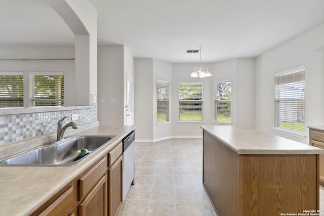 10107 Roseangel, Helotes, TX 78023 - kitchen featuring light countertops, plenty of natural light, and brown cabinetry