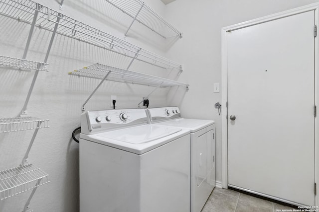 10107 Roseangel, Helotes, TX 78023 - washroom featuring washing machine and clothes dryer and light tile patterned flooring