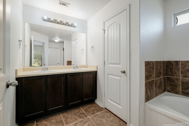 11750 Caraway, San Antonio, TX 78245 - bathroom featuring double vanity, tile patterned floors, and a bath