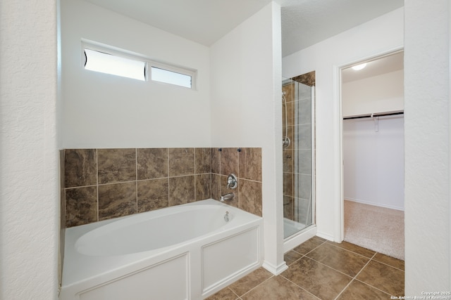 11750 Caraway, San Antonio, TX 78245 - full bathroom featuring a garden tub, a shower stall, a spacious closet, and tile patterned floors