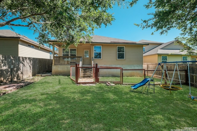 11750 Caraway, San Antonio, TX 78245 - rear view of property with a fenced backyard and a playground