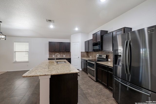 11750 Caraway, San Antonio, TX 78245 - kitchen with refrigerator with ice dispenser, double oven range, black microwave, decorative backsplash, and light stone countertops