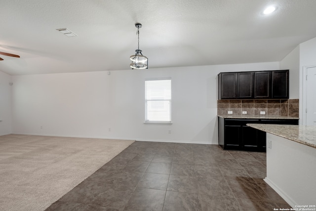 11750 Caraway, San Antonio, TX 78245 - kitchen featuring a ceiling fan, decorative backsplash, pendant lighting, and dark cabinets