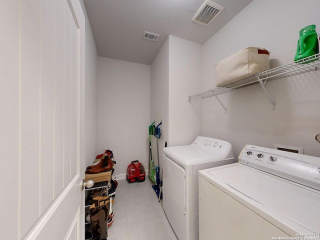 7621 Cypress, Boerne, TX 78015 - laundry room featuring washer and clothes dryer and light tile patterned floors
