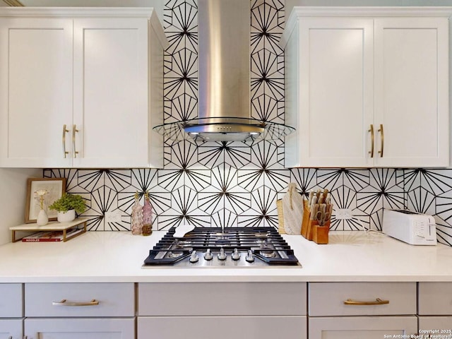 7621 Cypress, Boerne, TX 78015 - kitchen with stainless steel gas cooktop, decorative backsplash, light countertops, wall chimney range hood, and white cabinets