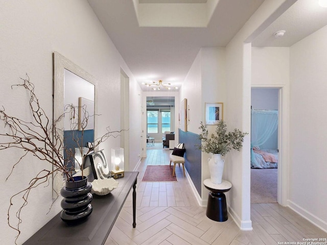 7621 Cypress, Boerne, TX 78015 - hall featuring a chandelier and baseboards