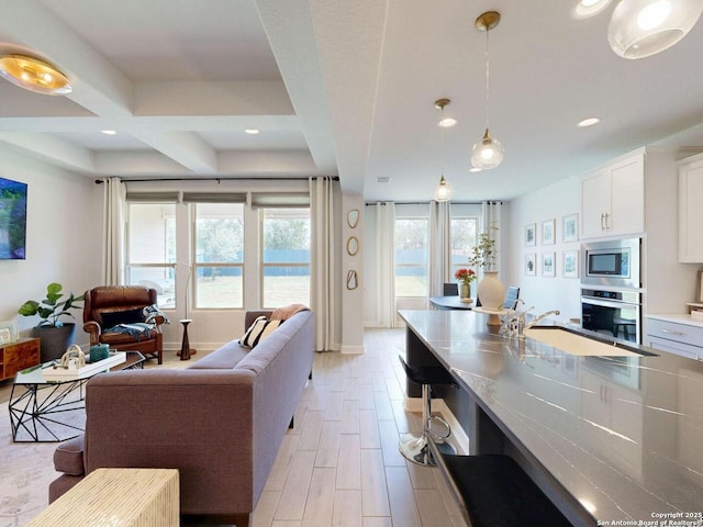 7621 Cypress, Boerne, TX 78015 - kitchen featuring stainless steel appliances, white cabinetry, decorative light fixtures, open floor plan, and recessed lighting