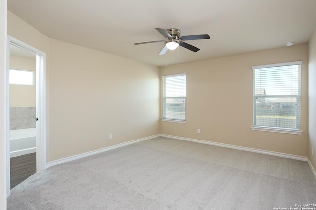 13027 Maestro Spark, San Antonio, TX 78252 - spare room featuring light colored carpet, ceiling fan, and plenty of natural light