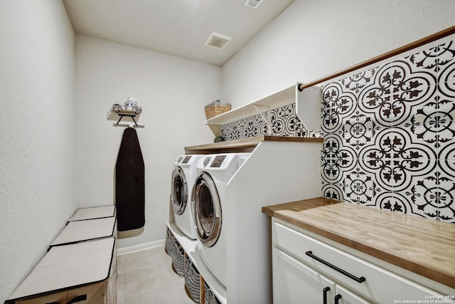 13019 Louberg, San Antonio, TX 78253 - washroom featuring washing machine and dryer, light tile patterned floors, and cabinet space