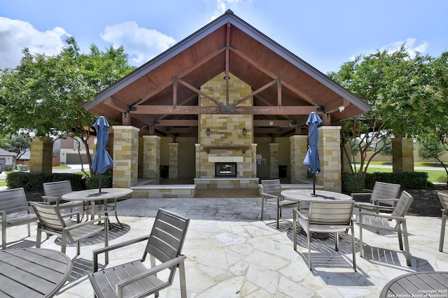 13019 Louberg, San Antonio, TX 78253 - view of patio / terrace with an outdoor stone fireplace, a gazebo, and outdoor dining area