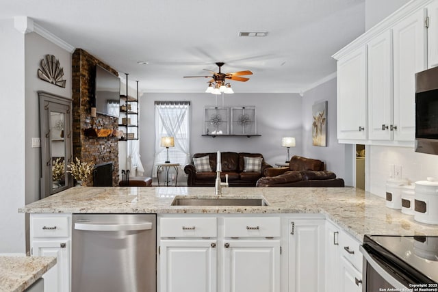 2723 Sierra Salinas, San Antonio, TX 78259 - kitchen with stainless steel appliances, ceiling fan, backsplash, crown molding, and open floor plan