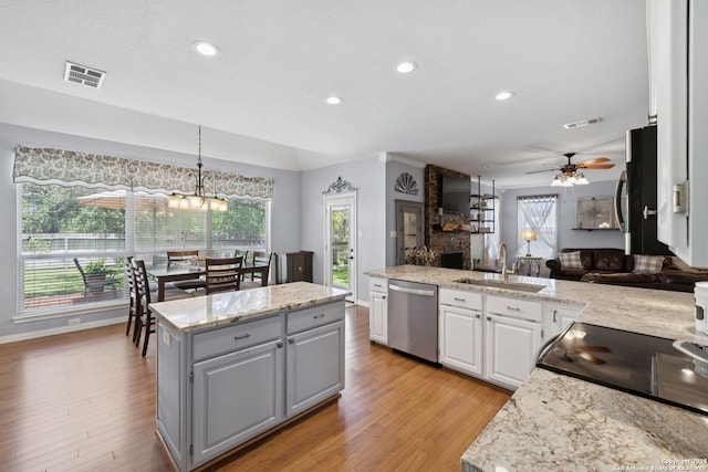 2723 Sierra Salinas, San Antonio, TX 78259 - kitchen with appliances with stainless steel finishes, ceiling fan, light wood-style floors, white cabinetry, and decorative light fixtures