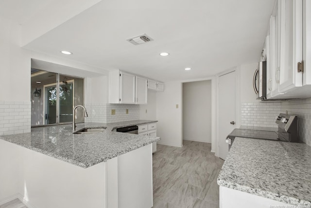 114 Crystal Cyn, Universal City, TX 78148 - kitchen with stainless steel appliances, a peninsula, decorative backsplash, and recessed lighting