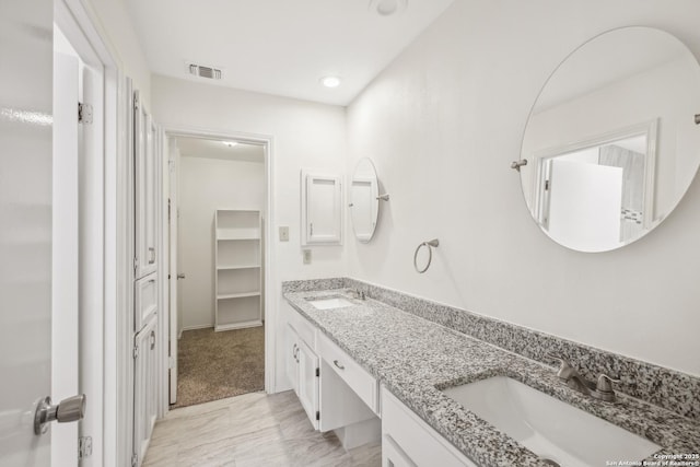 114 Crystal Cyn, Universal City, TX 78148 - bathroom featuring double vanity, a closet, marble look tile flooring, and recessed lighting
