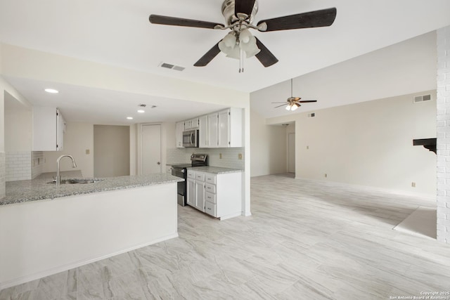 114 Crystal Cyn, Universal City, TX 78148 - kitchen featuring stainless steel appliances, backsplash, white cabinetry, a ceiling fan, and light stone countertops