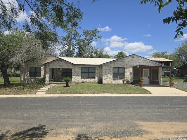 501 Green St, Poth, TX 78147 - view of front of home featuring stone siding and a front lawn