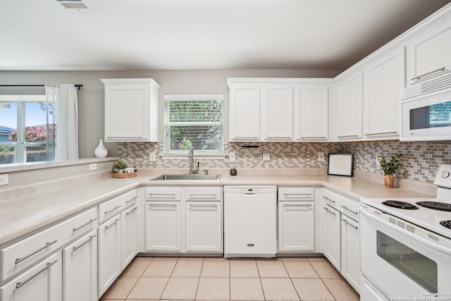 614 Granite Clf, San Antonio, TX 78251 - kitchen with white appliances, tasteful backsplash, white cabinets, and healthy amount of natural light