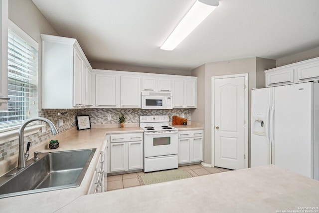 614 Granite Clf, San Antonio, TX 78251 - kitchen featuring white appliances, backsplash, light tile patterned floors, white cabinetry, and light countertops