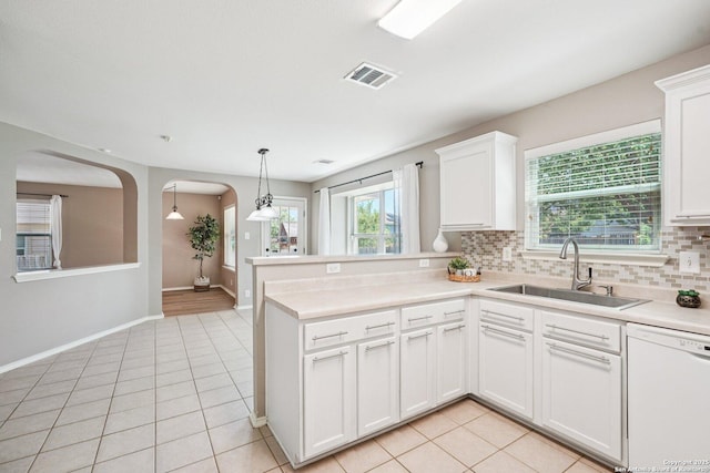 614 Granite Clf, San Antonio, TX 78251 - kitchen featuring white dishwasher, light tile patterned flooring, arched walkways, and backsplash