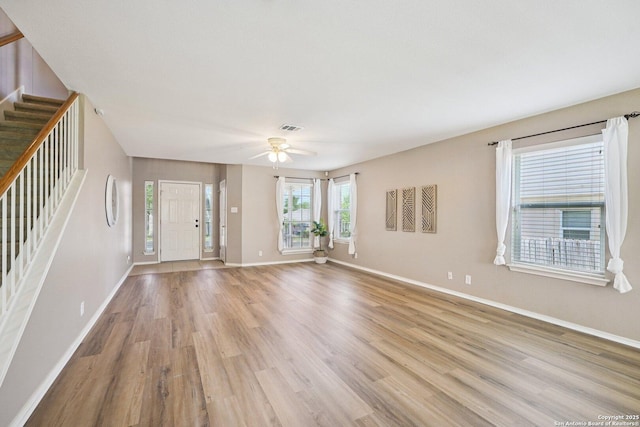 614 Granite Clf, San Antonio, TX 78251 - unfurnished living room with stairway, light wood-style flooring, and ceiling fan