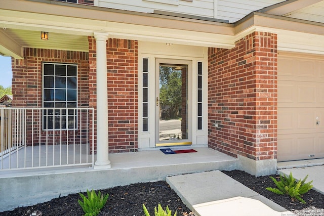 614 Granite Clf, San Antonio, TX 78251 - property entrance with a garage, covered porch, and brick siding