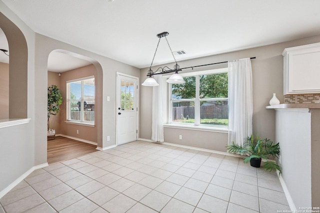 614 Granite Clf, San Antonio, TX 78251 - unfurnished dining area with arched walkways and light tile patterned floors