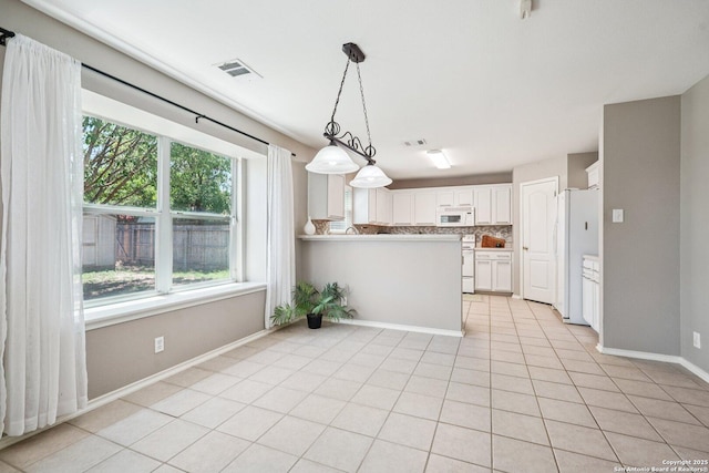 614 Granite Clf, San Antonio, TX 78251 - kitchen featuring white appliances, plenty of natural light, decorative backsplash, and white cabinetry