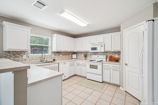 614 Granite Clf, San Antonio, TX 78251 - kitchen with white appliances, backsplash, and white cabinets