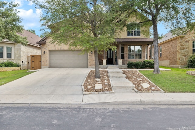 3535 Arroyo Grande, San Antonio, TX 78253 - view of front facade featuring driveway, a garage, a front yard, brick siding, and a gate