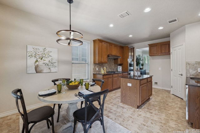 3535 Arroyo Grande, San Antonio, TX 78253 - kitchen with dark countertops, appliances with stainless steel finishes, a center island, brown cabinetry, and recessed lighting