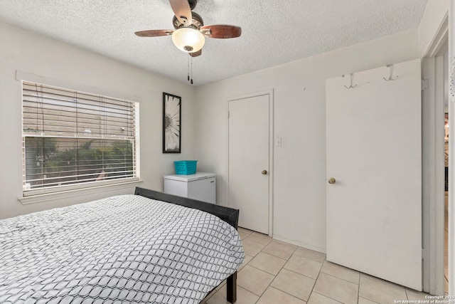 5322 Medical Unit A102, San Antonio, TX 78240 - bedroom featuring a textured ceiling, light tile patterned floors, and ceiling fan