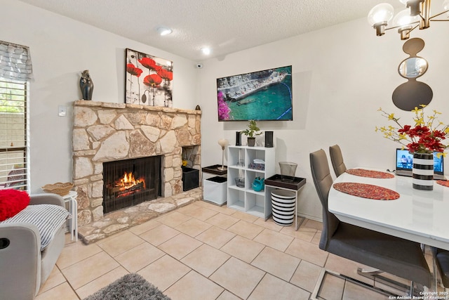 5322 Medical Unit A102, San Antonio, TX 78240 - tiled dining area with a fireplace, a textured ceiling, and a chandelier
