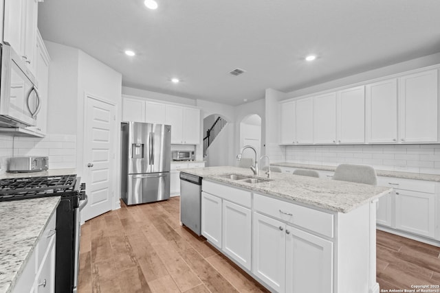 3415 Iron Cyn, Bulverde, TX 78163 - kitchen with appliances with stainless steel finishes, arched walkways, backsplash, and recessed lighting