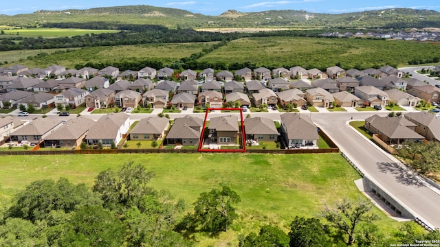 3415 Iron Cyn, Bulverde, TX 78163 - aerial view of residential area featuring property parcel outlined and a mountainous background