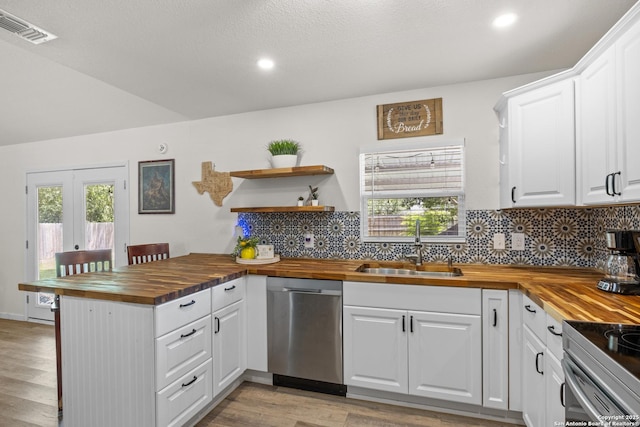 6402 Quiet Frst, San Antonio, TX 78239 - kitchen with wooden counters, appliances with stainless steel finishes, white cabinets, a peninsula, and recessed lighting