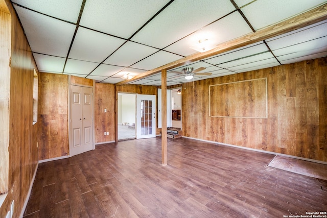 606 W Baetz Blvd, San Antonio, TX 78221 - empty room with wood walls, a drop ceiling, wood finished floors, ceiling fan, and french doors
