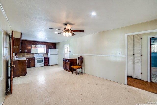 606 W Baetz Blvd, San Antonio, TX 78221 - kitchen featuring white appliances, light countertops, ceiling fan, light flooring, and dark brown cabinetry