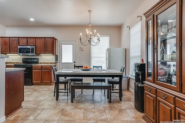 1038 Marquette, San Antonio, TX 78228 - dining room featuring a chandelier and plenty of natural light