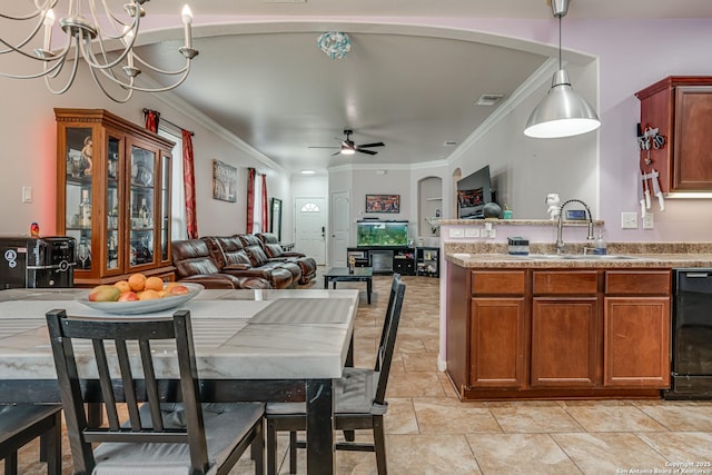 1038 Marquette, San Antonio, TX 78228 - dining space with ornamental molding, a chandelier, ceiling fan, and arched walkways