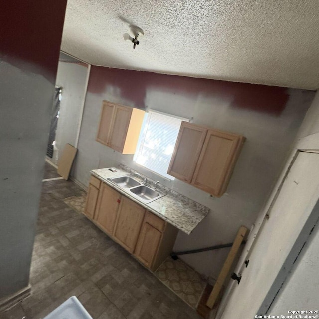 135 Roberts, San Antonio, TX 78207 - kitchen featuring a textured ceiling, light brown cabinetry, tile patterned floors, and light countertops